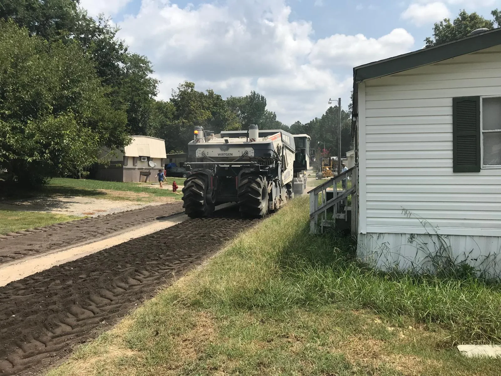 Cold reclaimer processing existing road material
