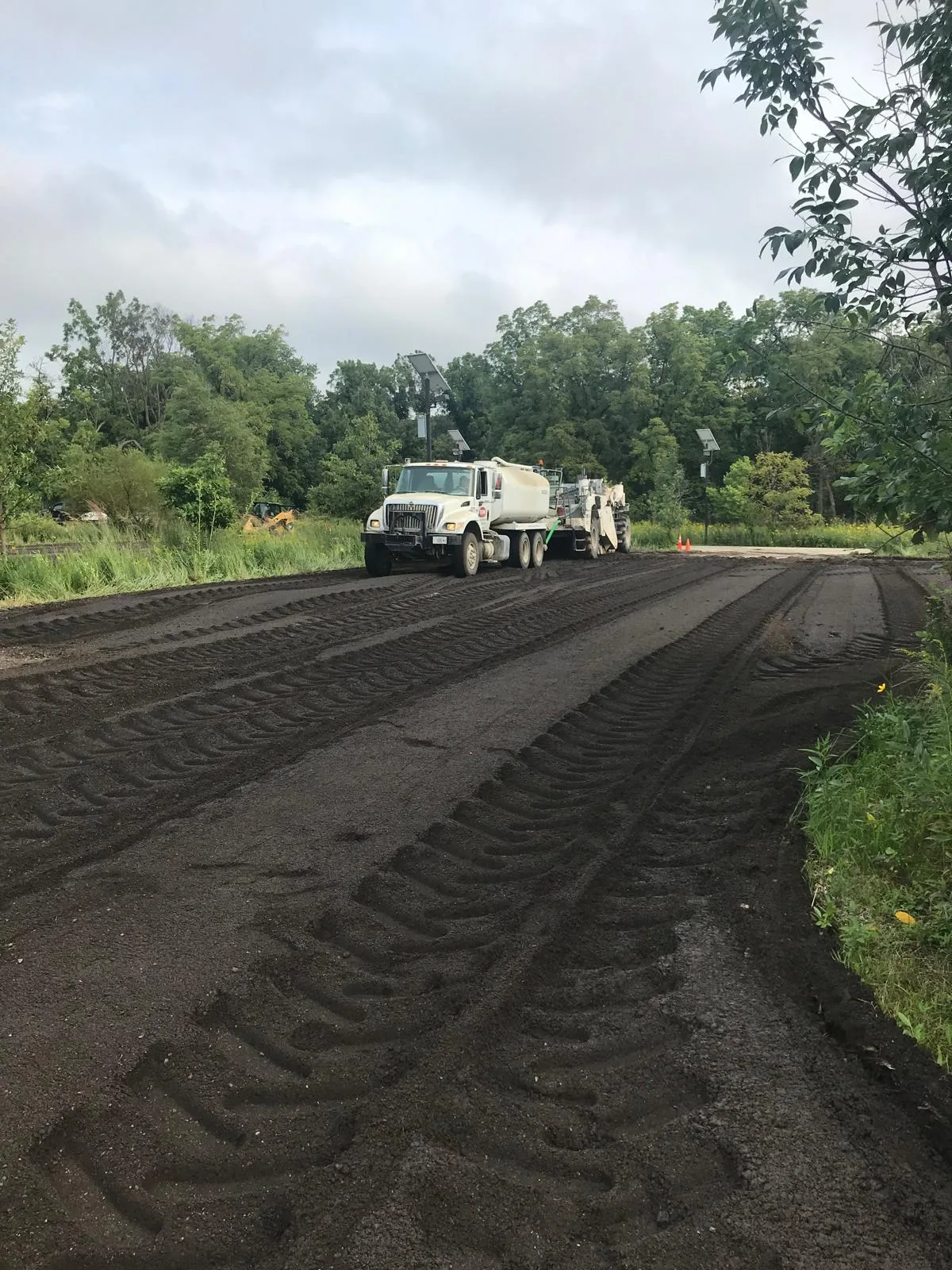 Cold reclaimer processing existing road material