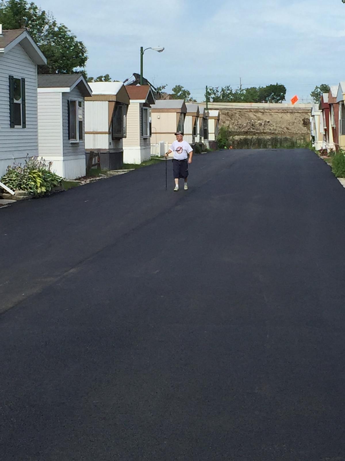 Resident walking on the renewed municipal street back in service
