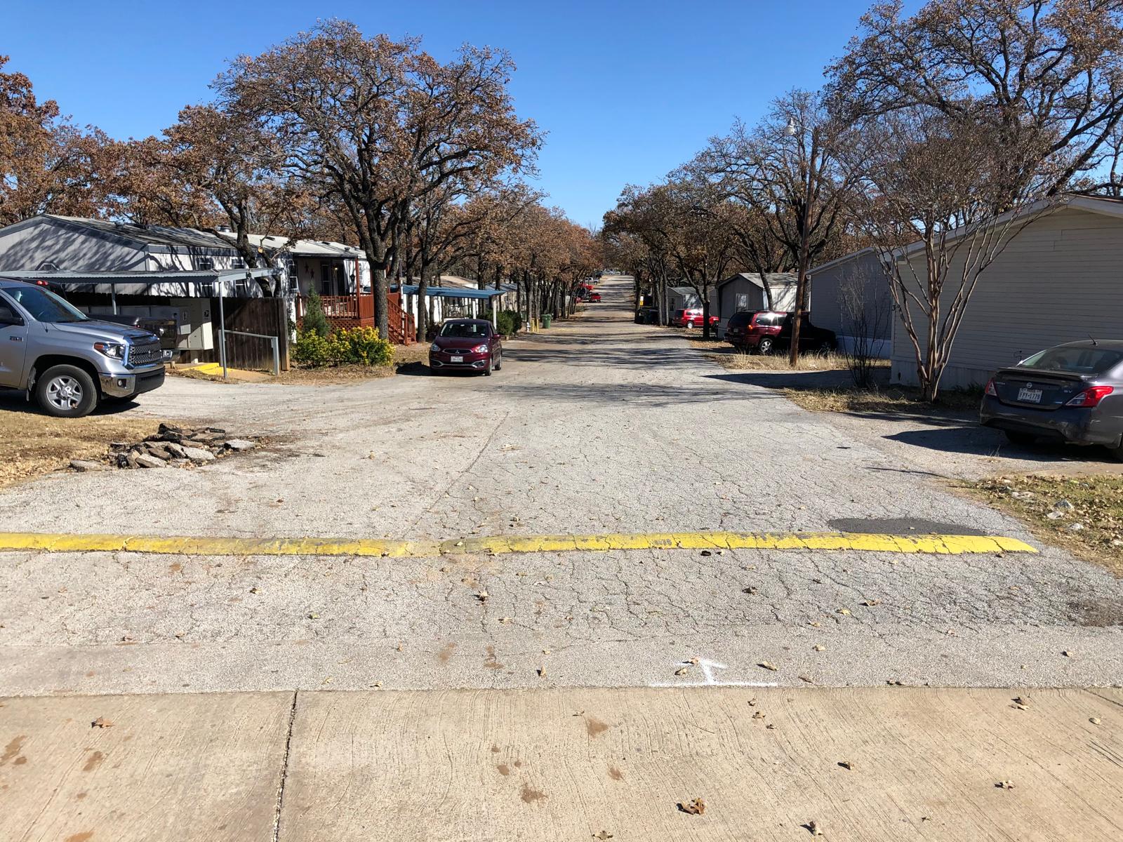 Cracked, degraded municipal street before treatment